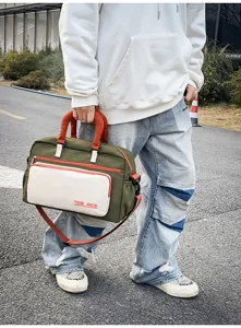 Travel duffel gym bag with vibrant color block design, front pocket, and durable straps.
