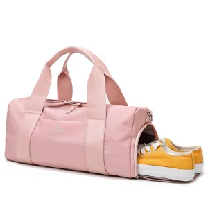 Pink sports gym duffel bag with separate shoe compartment and large capacity for travel fitness.