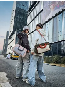 Large capacity travel shoulder bag for men and women, stylish fitness gym handbag with strap.