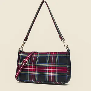 Vintage red plaid baguette bag for women, stylish underarm shoulder handbag with metal buckle.