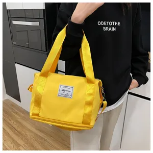 Compact yellow gym travel shoulder bag with durable canvas handles and spacious main compartment.