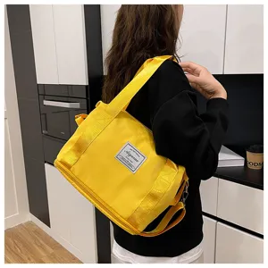 Small yellow gym bag, expandable travel duffel bag with shoulder strap and dry pockets.