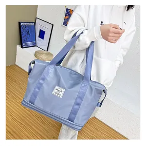 Blue travel gym duffel bag detail, showing expandable bottom layer and strong straps for daily fitness.