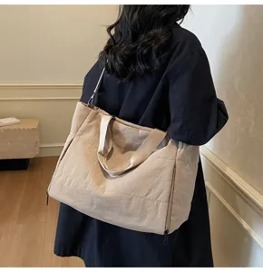 Detail view of the stylish quilted tote bag showing its large capacity and shoulder strap.