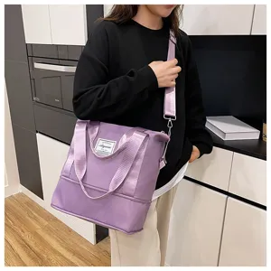 Detail view of purple fitness bag with sturdy woven strap and practical shoulder design.