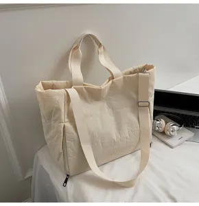 Detailed view of minimalist canvas tote bag, large capacity shoulder bag for daily casual use.