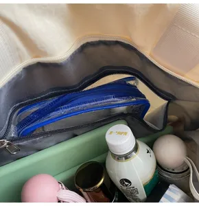 Detail view of canvas tote bag interior showing spacious compartments and organizing pockets.