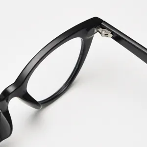 Close-up detail of stylish black cat eye glasses frame, showing fine metal hinge craftsmanship.