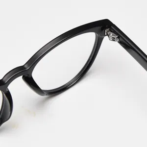 Black cat eye glasses frame detail close up view, stylish optical eyewear design.