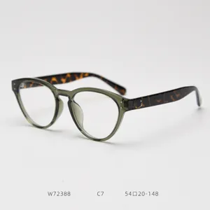 Detail view of retro cat-eye TR90 eyeglasses frame in olive green with tortoise temples.