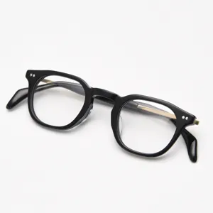 Detailed shot of black thick acetate optical glasses frame with metal temples, retro style.