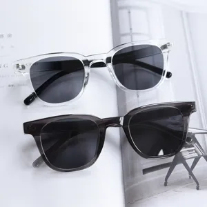 Stylish TR90 polarized sunglasses for men and women, clear and grey frames, UV400 protection.