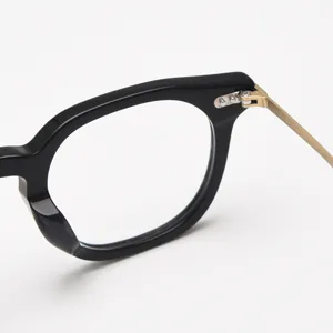 Close-up detail of black acetate and titanium optical glasses frame, retro vintage style.