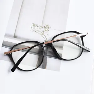 Detailed close-up of trendy black frame glasses with elegant rose gold metal brow accent.