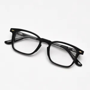 Close-up detail of black acetate vintage optical glasses frame with classic rivet design.