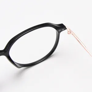 Close-up detail of TR90 black optical eyeglass frame with stylish rose gold metal temples.