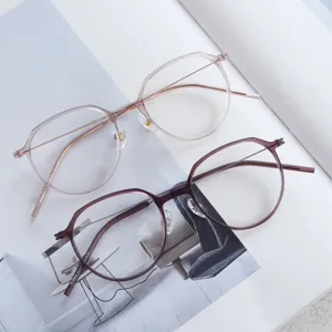 Detailed shot of two fashionable thin-rimmed round optical glasses frames in pink and purple colors.