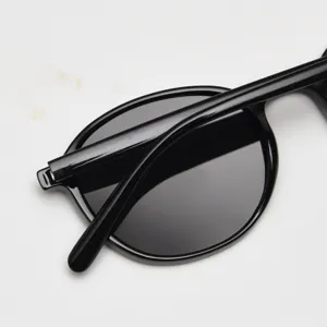 Close-up detail of retro round polarized sunglasses with durable TR90 frame in classic black.