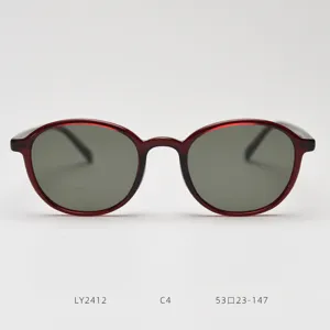 Close-up detail of retro TR90 sunglasses featuring dark polarized lenses and smooth oval red frames.