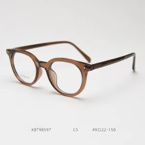 Detailed shot of retro round optical glasses frame with titanium temples and stylish brown finish.