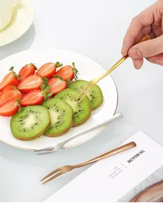Close-up detail of stainless steel fruit fork featuring polished finish and dual tines.