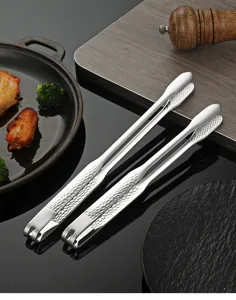 Stainless steel grilling tongs detail view, featuring hammered handle for kitchen BBQ.