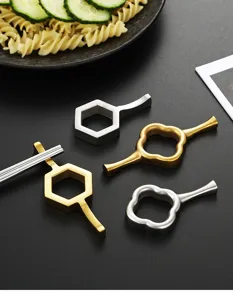 Stainless steel chopstick rest set, golden and silver geometric design for modern dining tables.