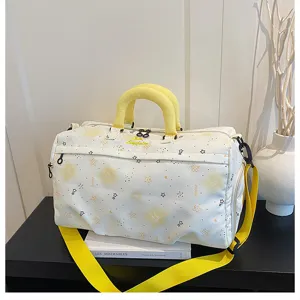 Large capacity travel duffel bag detail with durable zippers, yellow handles and star pattern.