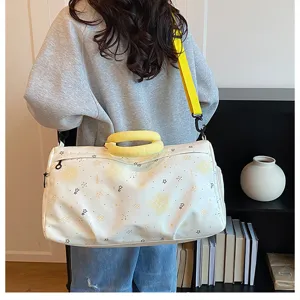 Large capacity travel duffel bag for women, lightweight gym and weekend overnight bag with yellow strap.