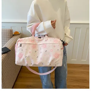 Detailed view of the pink gradient star print travel duffel bag with portable handles and strap.
