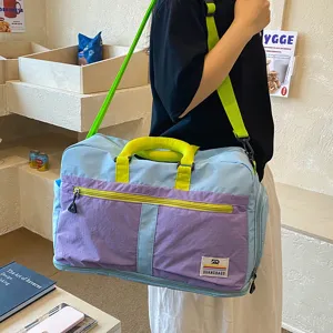 Detailed view of colorblocked travel duffel bag with convenient straps and pockets for trips.