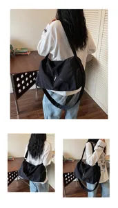 Grand sac de voyage noir pour femme, sac de sport et de fitness imperméable avec bandoulière.