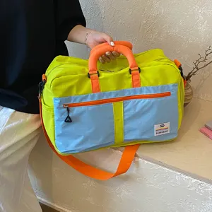 Colorblock travel duffel bag with large capacity and portable shoulder strap for gym.