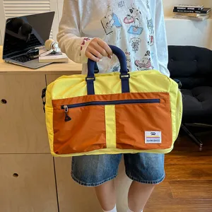 Colorblocked travel duffel bag with large capacity, durable handles and casual style.