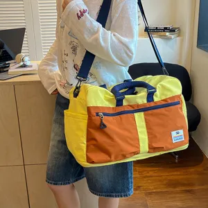 Stylish color-block travel duffel bag with large capacity, perfect for gym, commuting, and weekend trips.