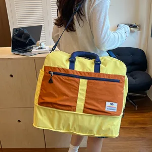 Colorblock travel duffel bag with large capacity, portable luggage bag for gym, trips.