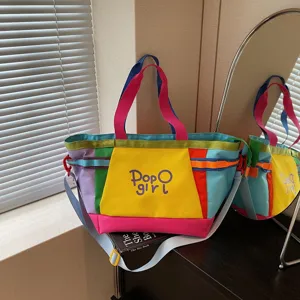 Colorful patchwork canvas shoulder tote bag detail view, showing handle and strap design.