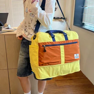 Color-blocked travel duffel bag, large capacity, durable fabric, ideal for gym and short trips.