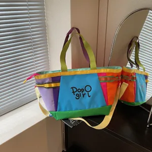 Detailed view of the colorblock canvas tote bag, showing the spacious interior and vibrant stitching.