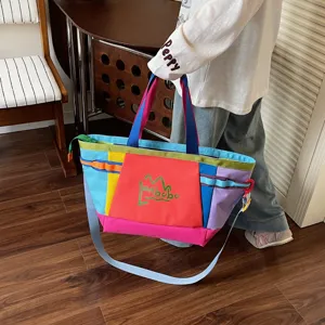 Detail view of the colorful color-block canvas tote bag, featuring large capacity design.