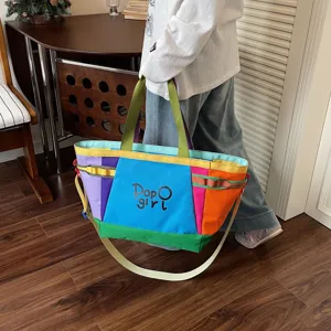 Color-blocked canvas tote bag detail, large capacity commuter travel bag, stylish lifestyle view.