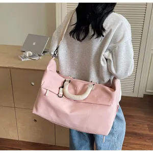 Large capacity pink travel duffel bag for women, lightweight casual gym sports bag with handles.