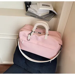 Stylish pink travel duffel bag with beige handles, large capacity weekender bag for short trips.