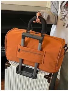 Large capacity travel duffel bag orange weekender bag with luggage sleeve for short trips fitness gym