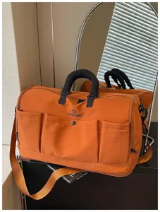 Large capacity travel duffel bag orange short trip luggage gym and yoga storage bag.