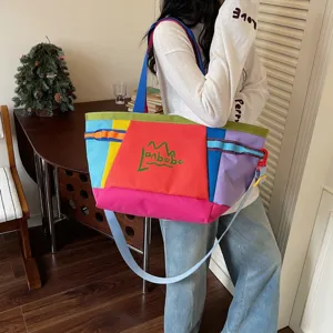 Detailed view of the colorful patchwork tote bag showcasing vibrant color blocking and sturdy straps.