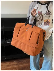Large capacity travel duffel bag with multiple front pockets, ideal for short trips and daily use.