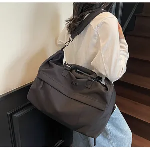 Large capacity travel duffel bag for women and men, stylish shoulder bag for gym and sports.