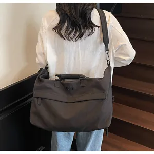 Large capacity travel duffel bag for women and men, lightweight canvas crossbody shoulder bag.