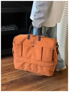 Detail view of large capacity travel duffel bag with front pockets and sturdy handles.
